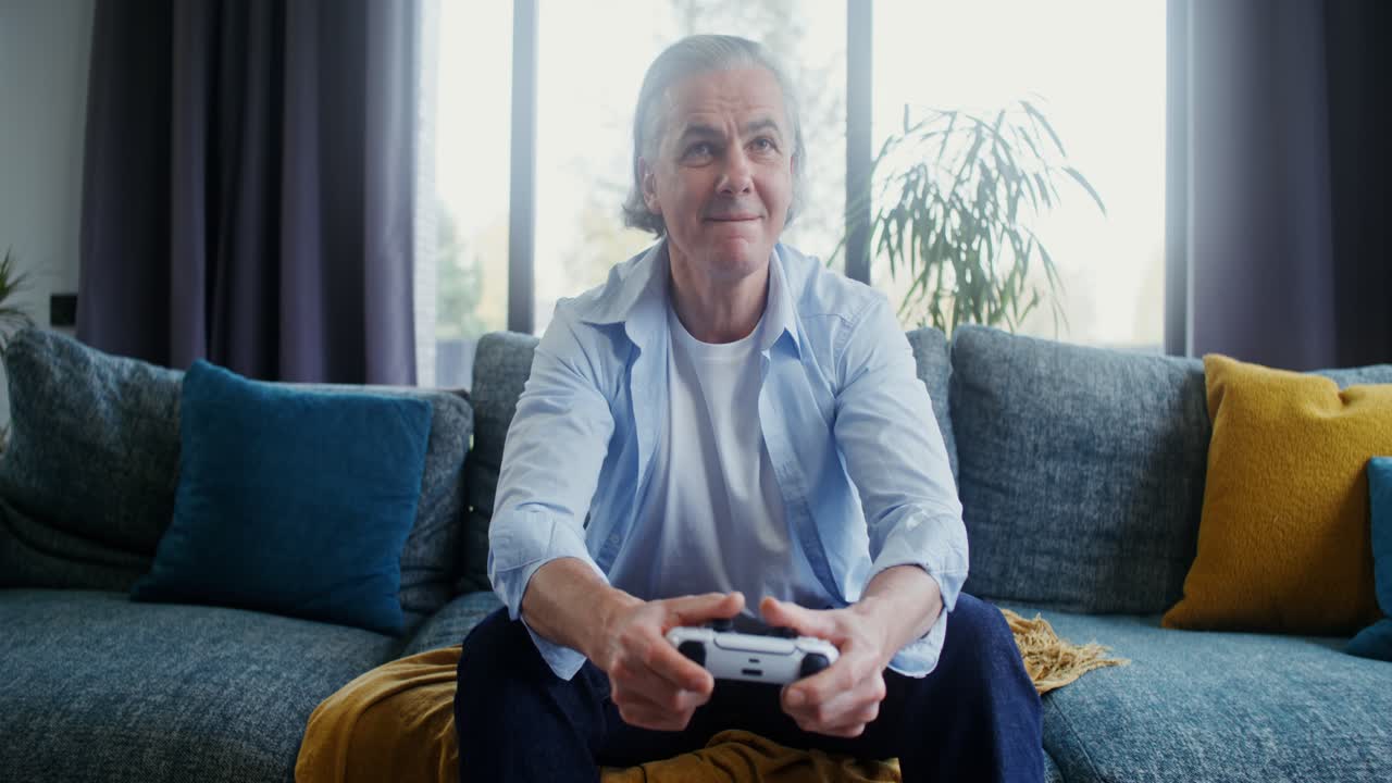 Elderly Man Playing Video Games on Couch