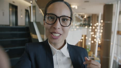 businesswoman taking a selfie in a modern office building