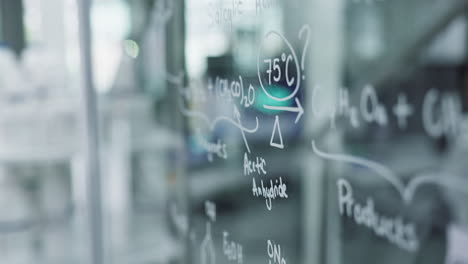 chemical formulas on a glass board