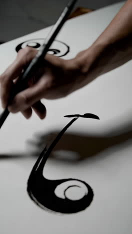 hand painting with ink and yin yang symbols