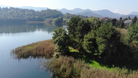 contaminated lake used for chemical disposal with residential homes nearby, aerial dolly in view