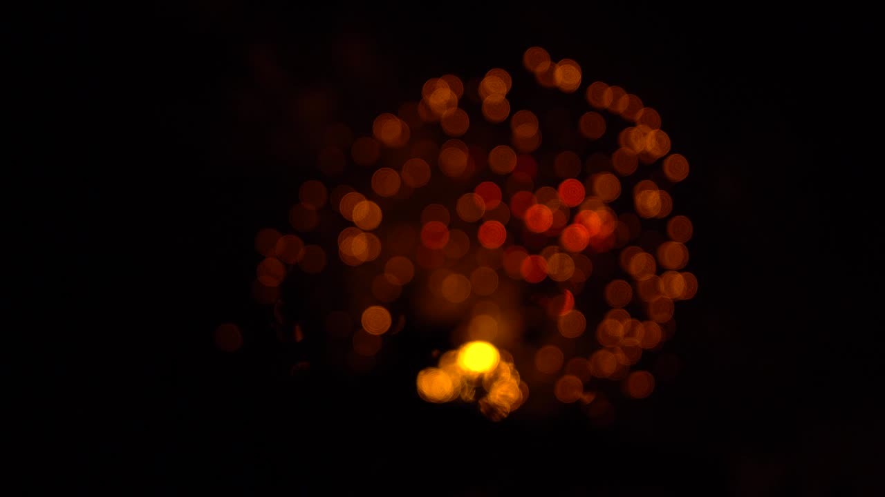 Red and gold circle fireworks with bokeh and optical effect. Holiday background