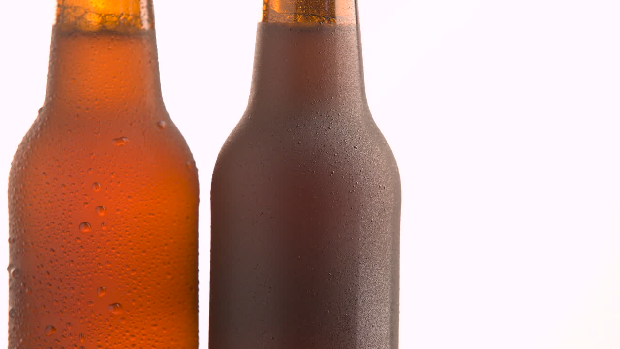 Three beer bottle rotating on white background