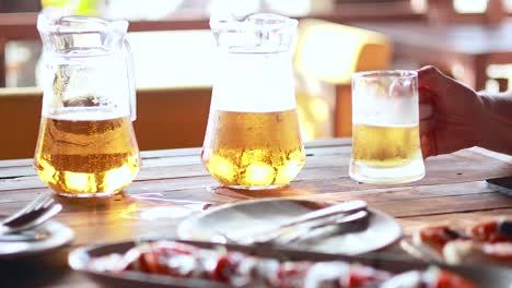 hands exchanging drinks at a table setting