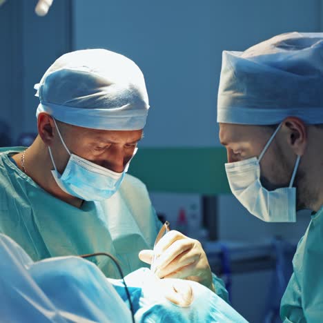 doctors do plastic cosmetic operation. blepharoplasty on face of a female. plastic surgery operation for modifying the eye region of the face in medical clinic.