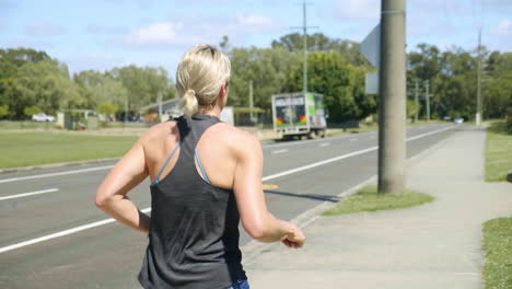 4k slow motion of female running down suburban neighborhood street