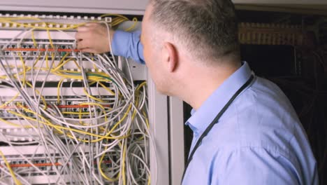 technician using laptop to analyse server