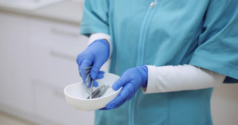 doctor sorts medical instruments at healthcare clinic