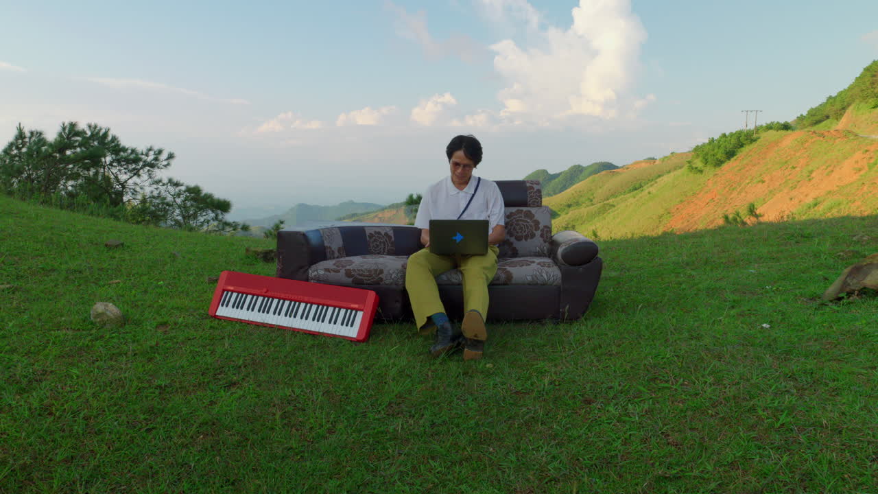 artist using a laptop with AI software installed helping musician find inspiration for new song idea