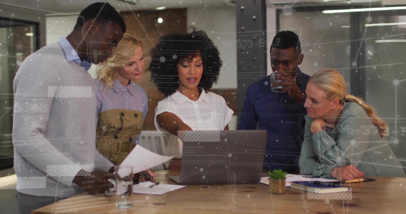 Presenter launching slides on laptop and pointing at screen in business meeting, team writing notes
