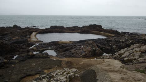 extra wide shot at low-level shot of mousehole rock pool tidal swim pool, cornwall