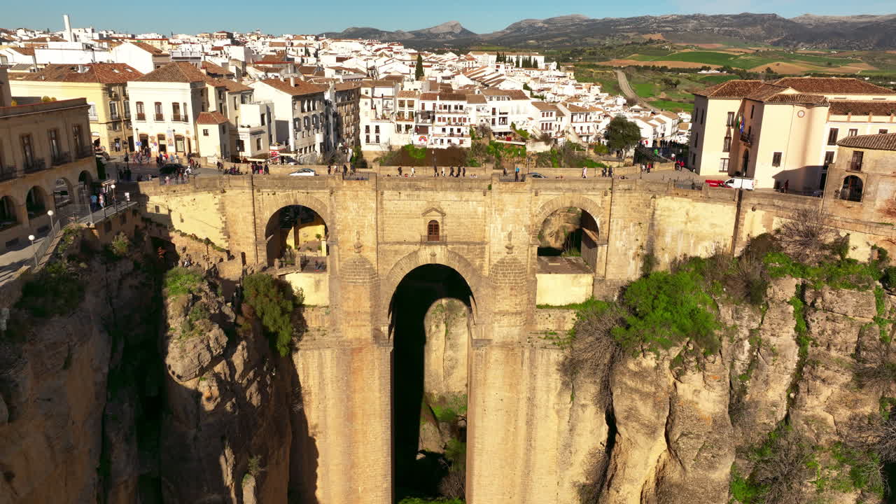 Ascending forward flying drone shot of Ronda City in Spain, Europe. Arch bridge, homes, streets are located on the rocky cliff. High quality 4k prores footage.