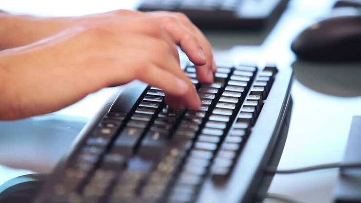 Hands typing on a keyboard