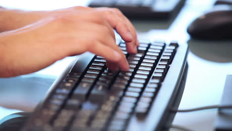 hands typing on a keyboard