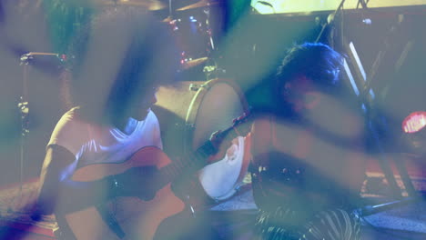 man playing acoustic guitar with woman checking smartphone in music industry, animated sound waves