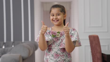 Happy-Indian-kid-girl-showing-thumbs-up