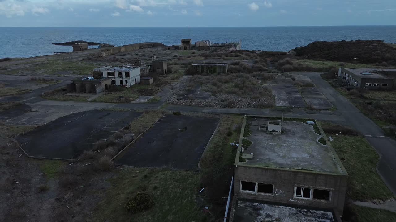 Veduta aerea di un impianto chimico Octel in disuso, con uffici industriali fatiscenti e terreni abbandonati