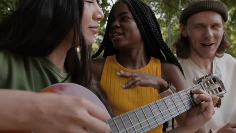 diverse group of friends playing music together outdoors
