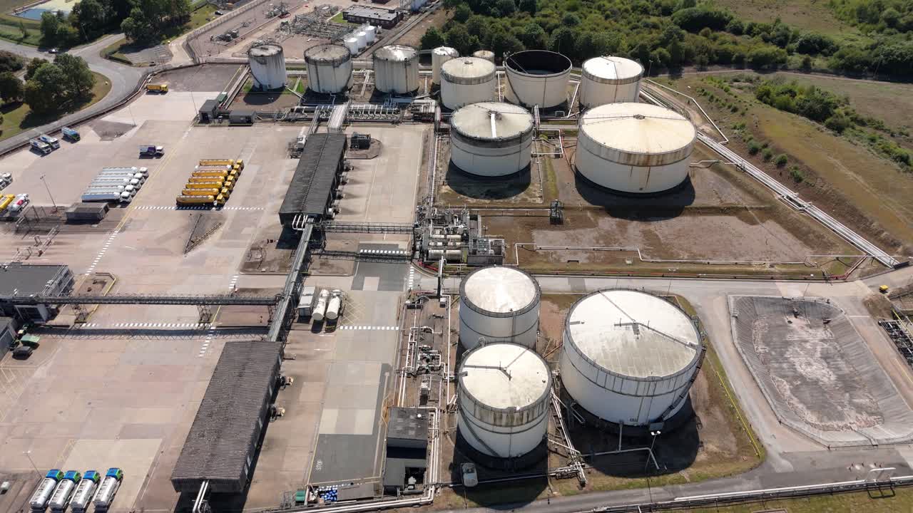 Aerial drone footage over Kingsbury England UK showing chemical plant, fuel silos, energy distribution and gas power generation industrial site