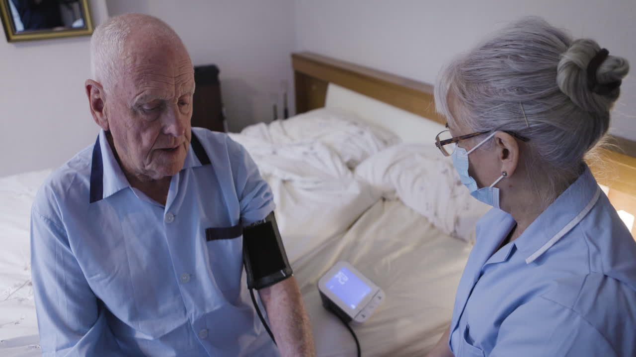 Nurse Checking Blood Pressure of Elderly Man