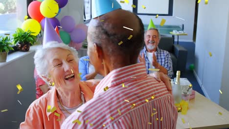 senior friends celebrating a birthday indoors