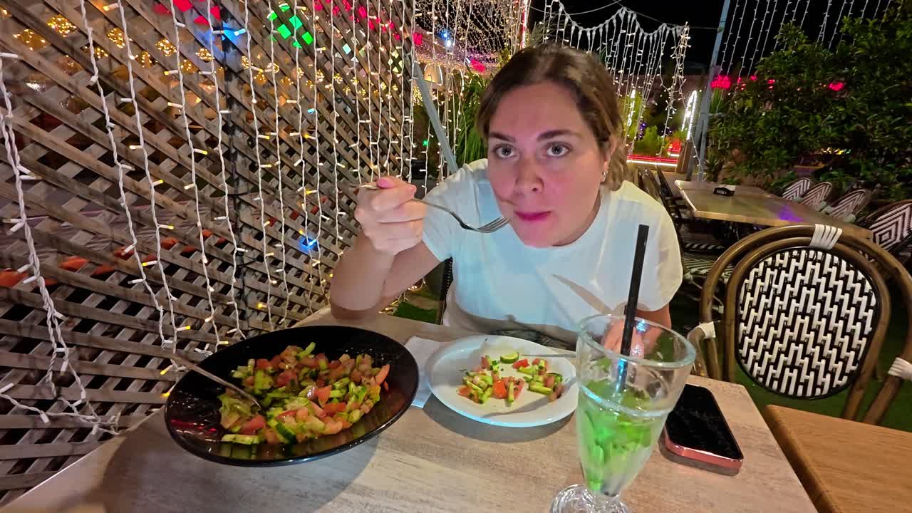 Woman in Deep Thought While Sitting at a Cafe at Night