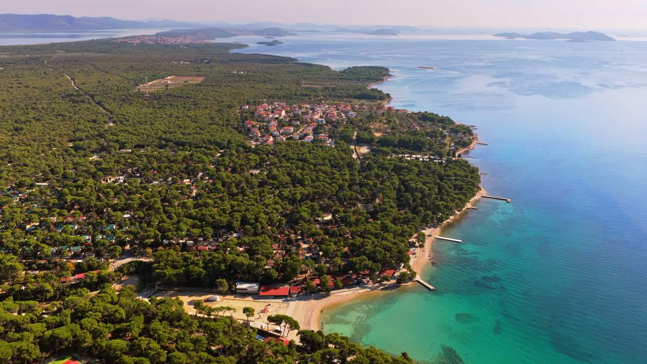 Aerial drone view of the vast pine forest stretching along the coast near Biograd na Moru, Croatia