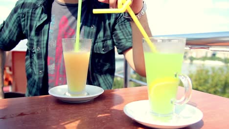 young man drinking lemonade in cafe