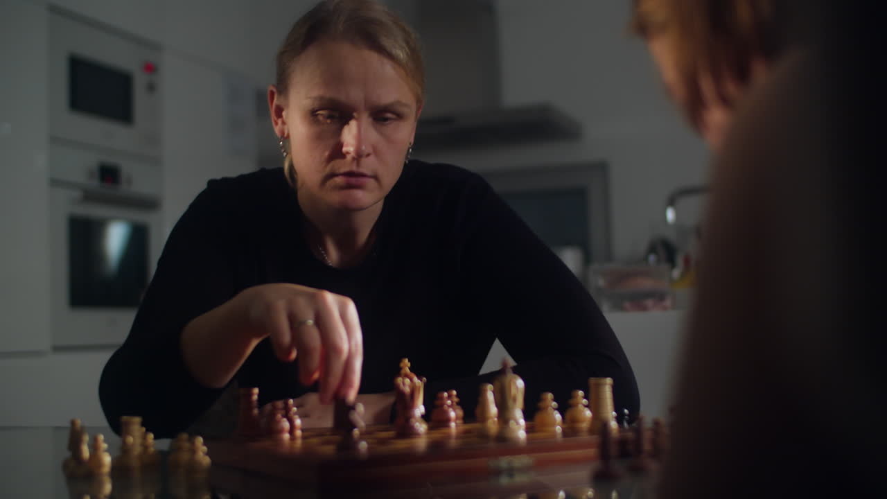 Mother and Son Engage in a Game of Chess