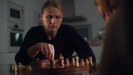 mother and son engage in a game of chess