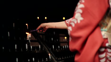 woman in kimono lighting candles