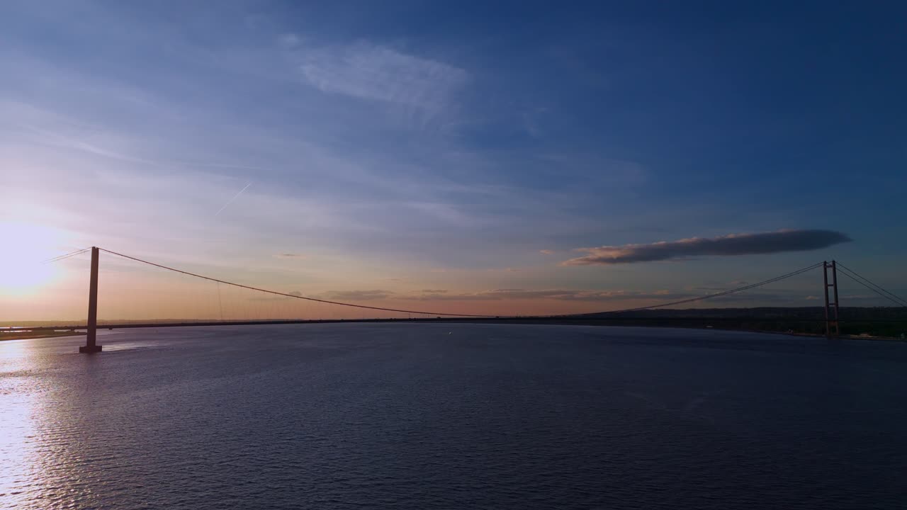 Twilight's magic: Humber Bridge, cars weaving their way in an aerial view
