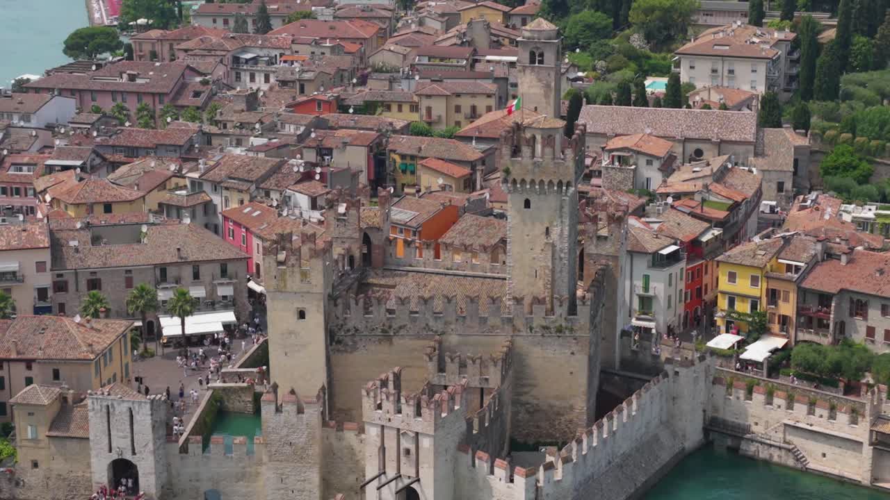 High angle of Scaliger Castle showing fortified walls and moat structure in crystal-clear waters