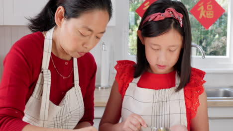 mother teaching child to cook food in the kitchen