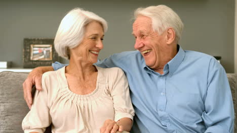 Elderly-couple-laughing-at-home