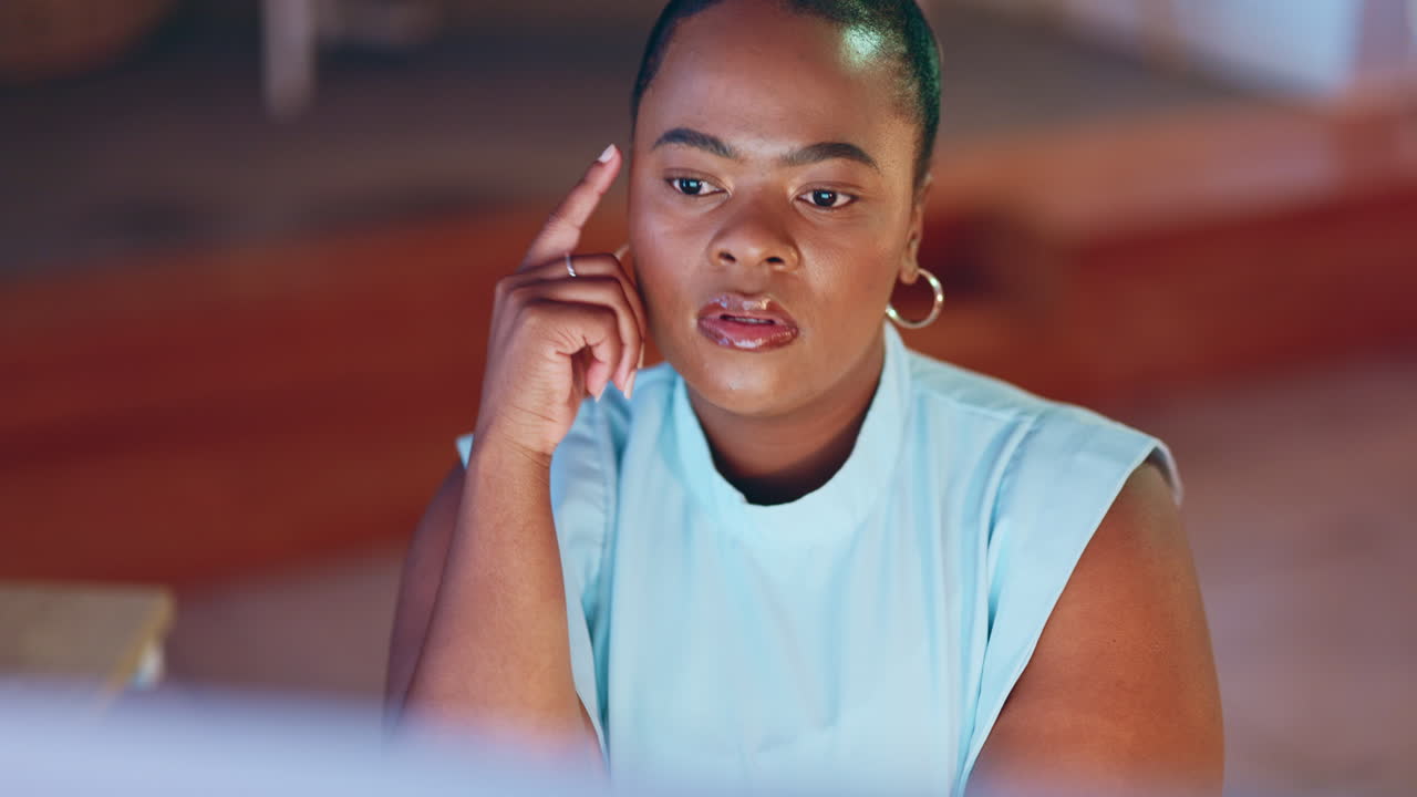 Serious, thinking and black woman on computer