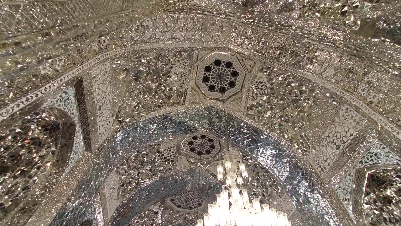 Indviklet spejlarbejde og krystallysekroner i en iransk moské