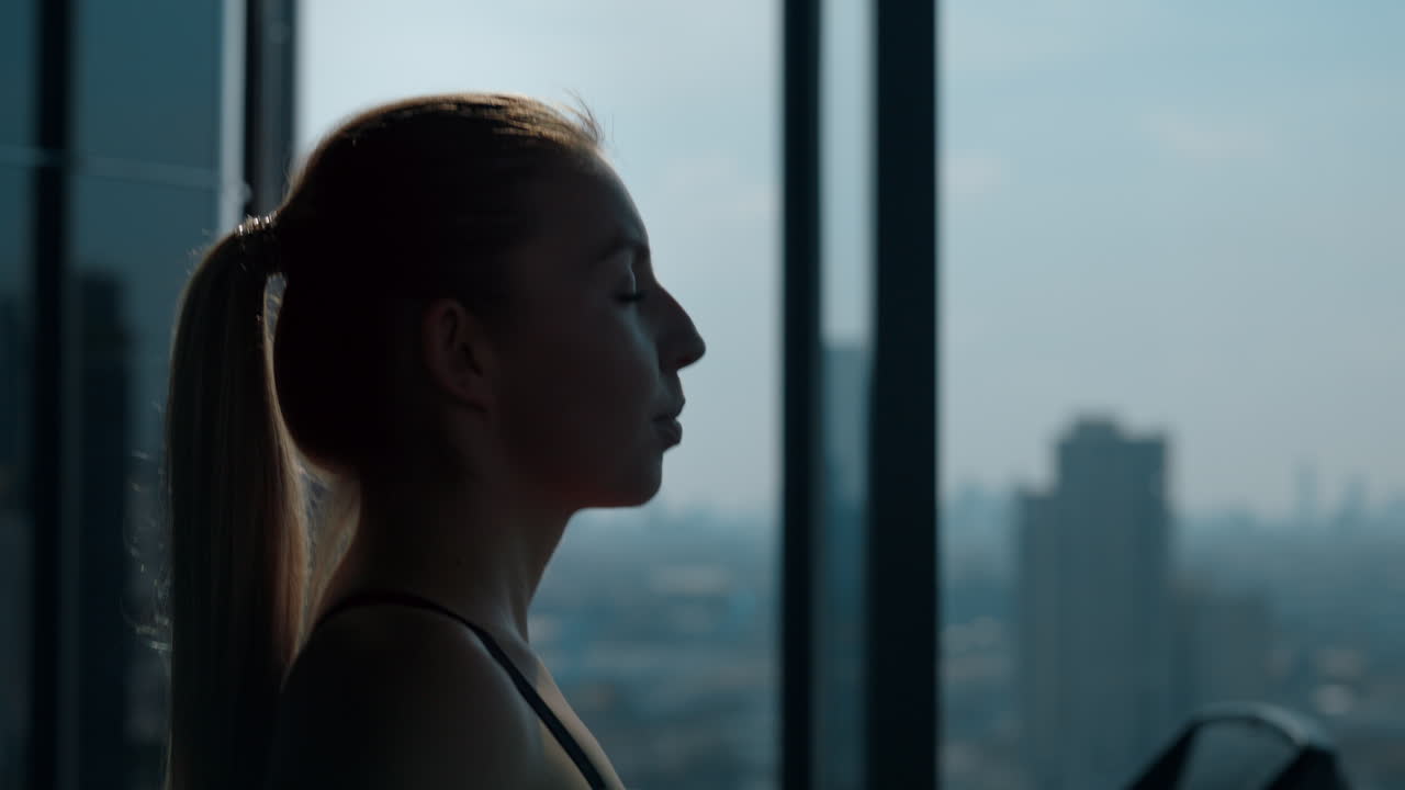 Woman's Profile Silhouette in a Gym with City View