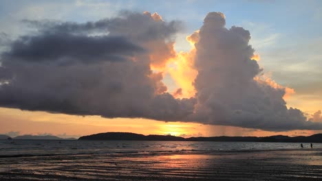 sunset over phuket from ao nang beach in krabi with stormy monsoon cumulonimbus clouds