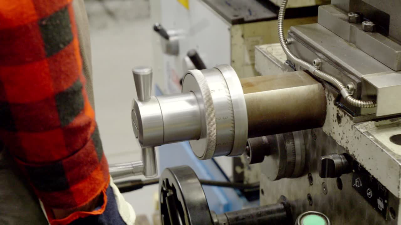 un empleado establece el valor en los instrumentos de medición de un torno metálico