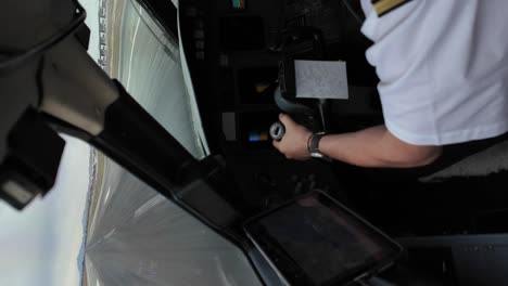 left shoulder, arm and hand of a white pilot during takeoff roll, wearing a white shirt and gallon