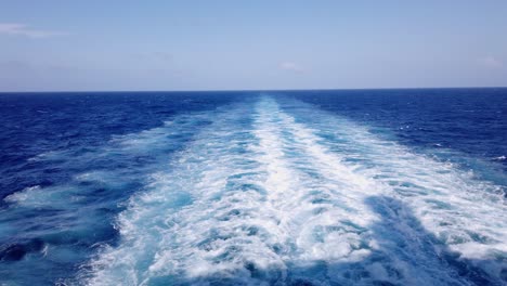 Amazing-blue-Caribbean-Sea-and-wake-of-cruise-ship-sailing-across-the-ocean