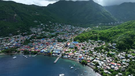 Aerial view of a town by the sea with mountains in the background
