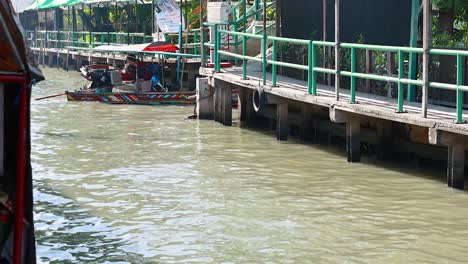 boat navigating canal at floating market