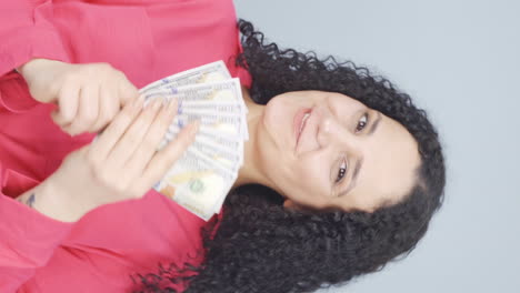 vertical video of the young woman loves money.