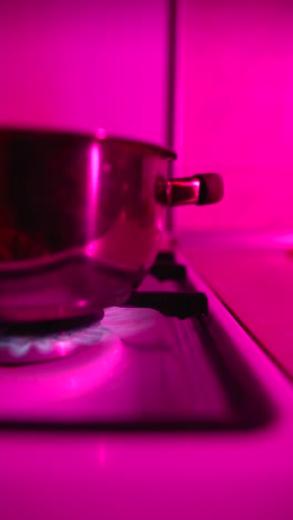 pink-lit kitchen pot on stove