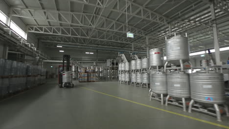 forklift carries the metal barrels