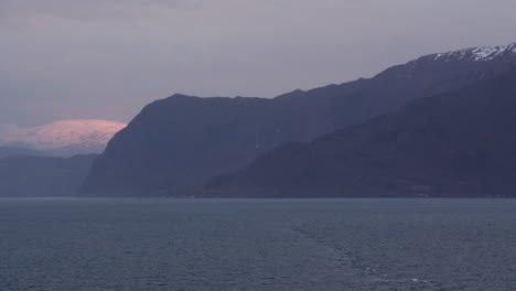 sunrise over the mountains at hardanger, hardangerfjorden fjord in early morning