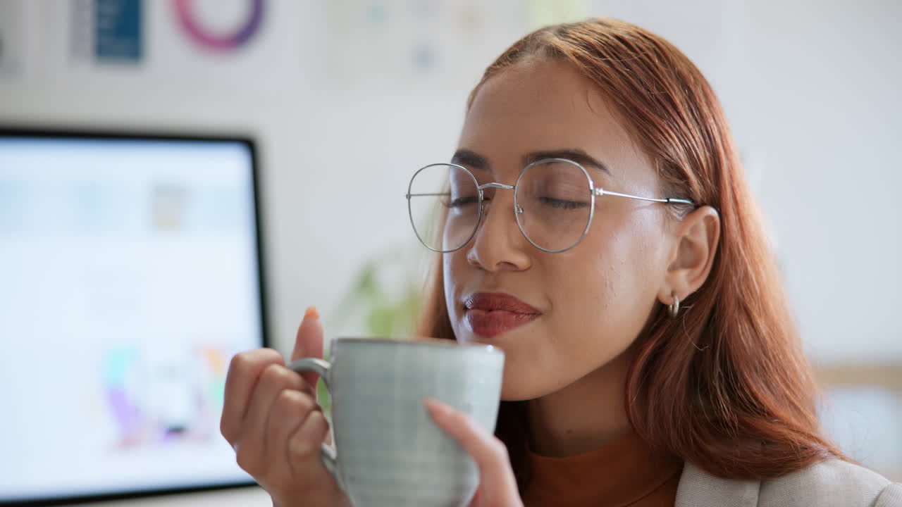 Woman drinking coffee while working