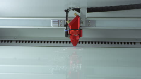un cortador láser en funcionamiento en un laboratorio de impresión 3d, filmado en r3d